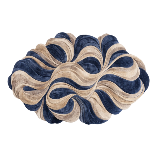 A sculptural, cloud-like decorative cushion or pouf with layered, wavy ruffles in navy blue and beige velvet, isolated on a white background.