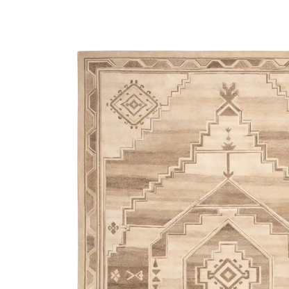Beige area rug with geometric pattern on a white background
