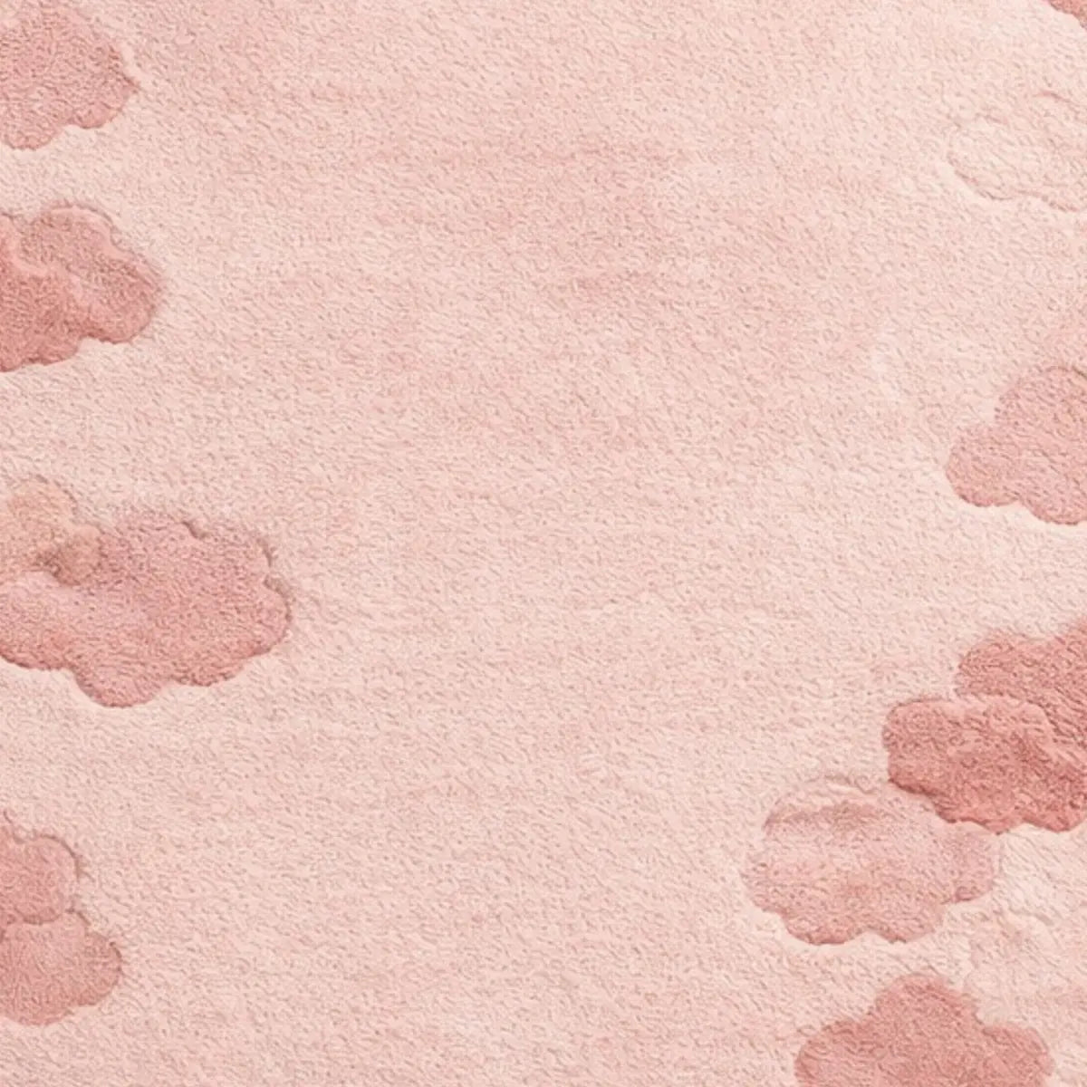 A close-up of a soft pink textured surface with scattered dusty pink cloud-like shapes around the edges and center.