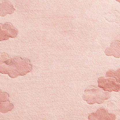 A close-up of a soft pink textured surface with scattered dusty pink cloud-like shapes around the edges and center.