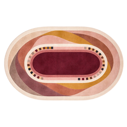 An oval area rug with a modern abstract design, featuring concentric shapes in dusty pink, mustard yellow, mauve, and a deep burgundy center, shown on a plain white background.