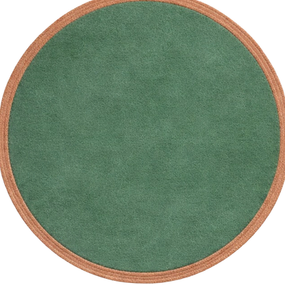 A round green rug with a textured, suede-like surface and a contrasting tan braided border, shown against a plain white background.