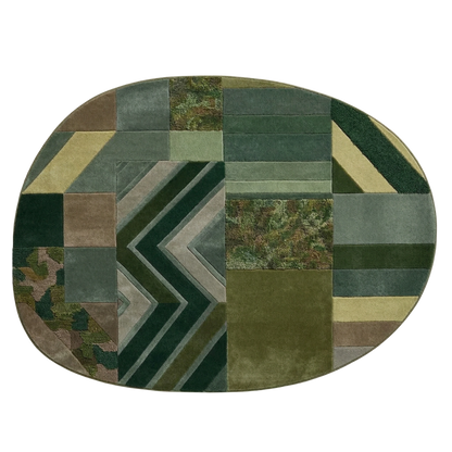 Modern green wool rug with chevron stripes, textured panels, and geometric design