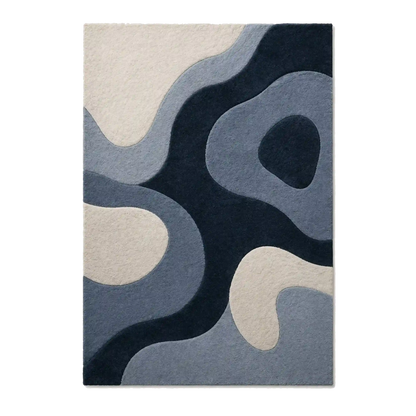An abstract area rug featuring organic, flowing shapes in navy blue, slate blue, and cream, shown flat against a white background.
