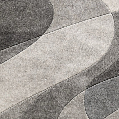 A close-up of a gray and off-white textured surface with flowing, abstract curved shapes.