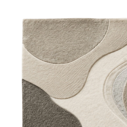 Close-up of a modern area rug with an abstract organic wavy pattern in beige, cream, taupe, and dark gray, shown on a white background.