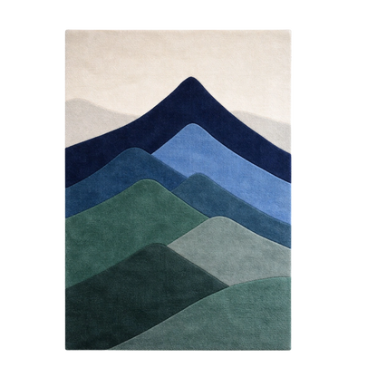 A rectangular area rug featuring a stylized layered mountain design in shades of navy, blue, green, and gray on a light beige background.