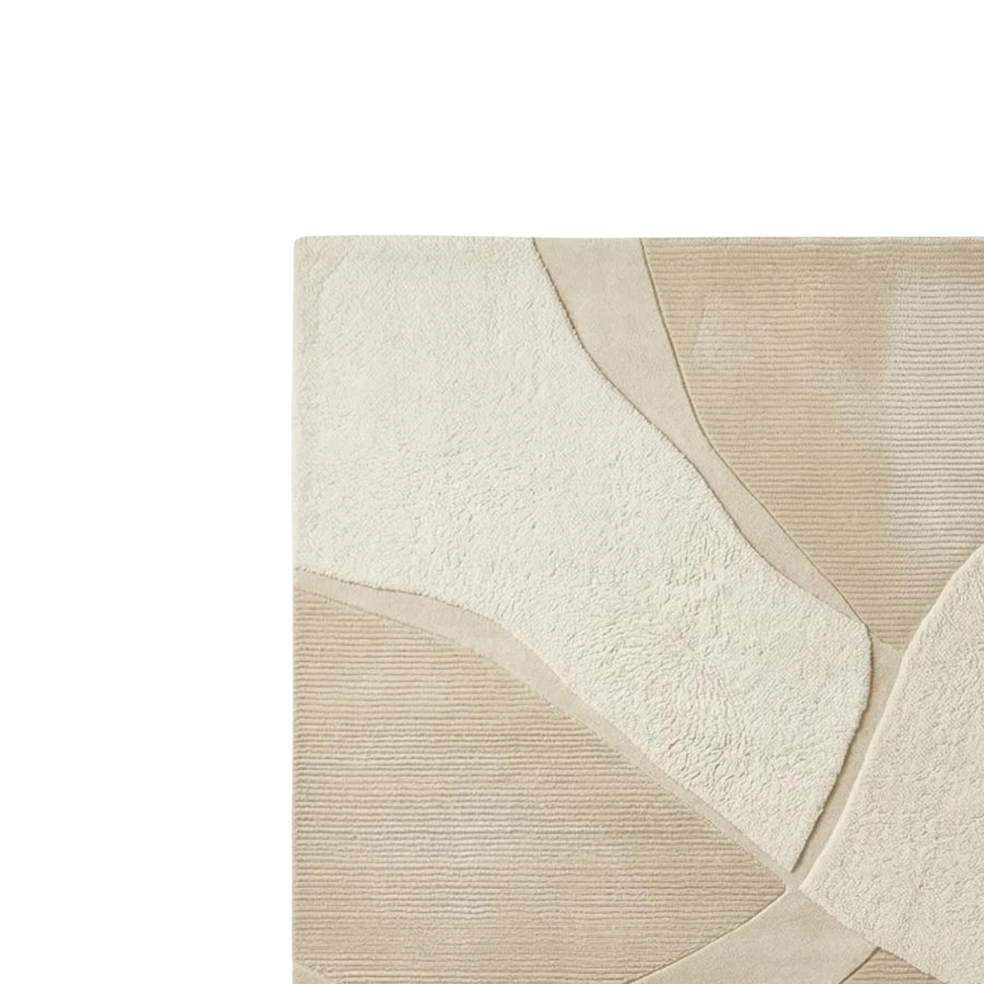 Close-up of a textured area rug with an abstract organic pattern in cream and beige tones.