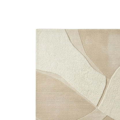 Close-up of a textured area rug with an abstract organic pattern in cream and beige tones.