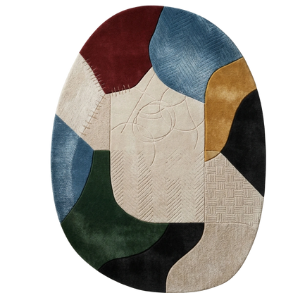 An oval area rug with an abstract patchwork design featuring textured sections of burgundy, blue, beige, mustard, black, green, and cream on a white background.