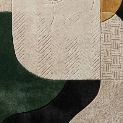 Abstract area rug with a modern geometric design featuring textured sections in cream, forest green, black, and a small gold accent.
