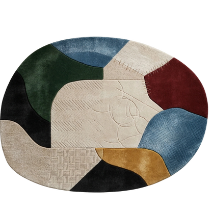 An oval area rug with an abstract patchwork design featuring multiple colors and textures, including blue, green, beige, burgundy, black, and gold, shown on a plain white background.