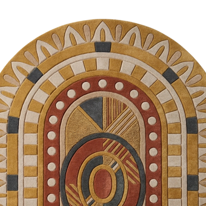 Mustard and terracotta oval rug with symmetrical tribal pattern and sculpted detailing