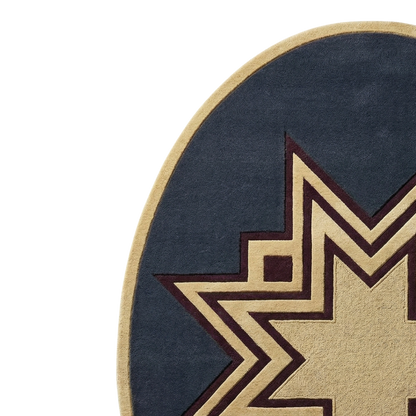 Close-up of a round rug with a navy blue field, a beige border, and a large geometric star motif in beige and dark brown.
