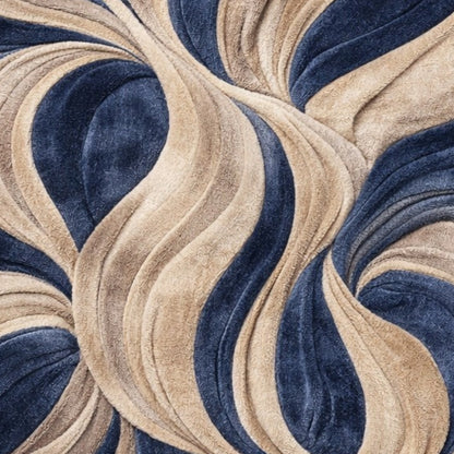 A close-up of a plush, wavy patterned fabric or rug in navy blue and warm beige, showing the soft texture and flowing, layered design.