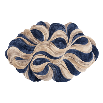 A sculptural, cloud-like decorative cushion or pouf with layered, wavy ruffles in navy blue and beige velvet, isolated on a white background.