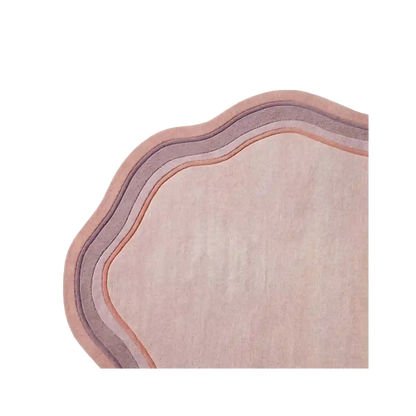 Luxury pink pastel wool area rug with soft blush center and sculpted wavy edge design for modern interiors