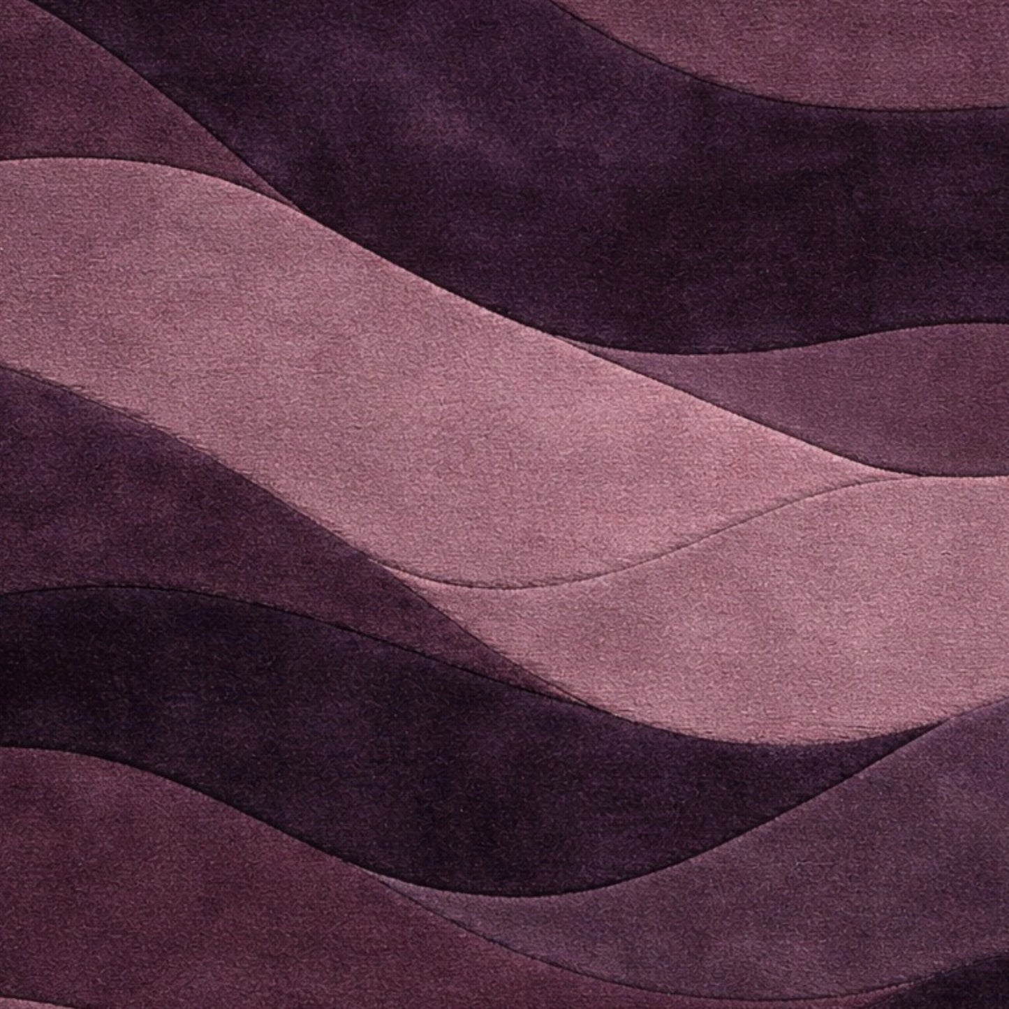 A close-up of a wavy, layered fabric or material surface in shades of purple and dusty pink, with a soft textured finish.