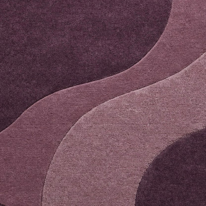 A close-up of a textured fabric or wallpaper pattern featuring abstract, flowing wavy shapes in shades of plum purple, mauve, and dusty rose.