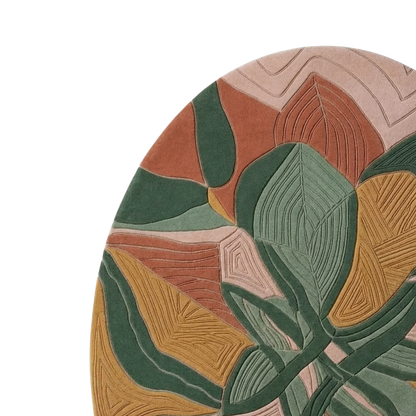 Close-up of a round area rug with an abstract botanical pattern in muted terracotta, sage green, mustard yellow, and blush pink tones on a white background.