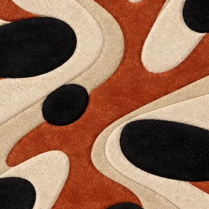 Abstract patterned area rug with organic wavy shapes in rust orange, cream, and black, shown in a close-up texture view.