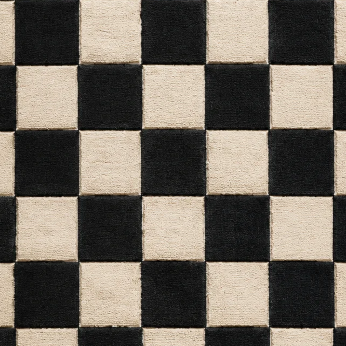 Close-up of black and ivory hand-tufted wool rug showing plush pile texture, defined checkerboard squares, and contrasting wool fibers.