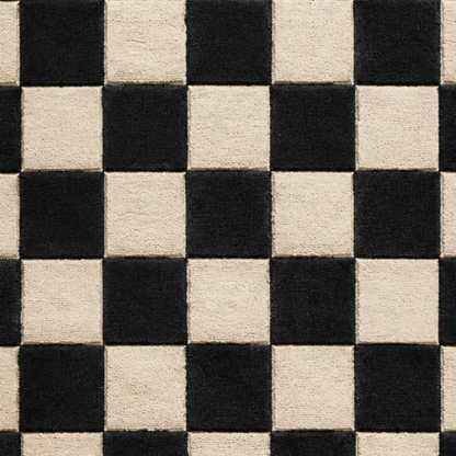 Close-up of black and ivory hand-tufted wool rug showing plush pile texture, defined checkerboard squares, and contrasting wool fibers.