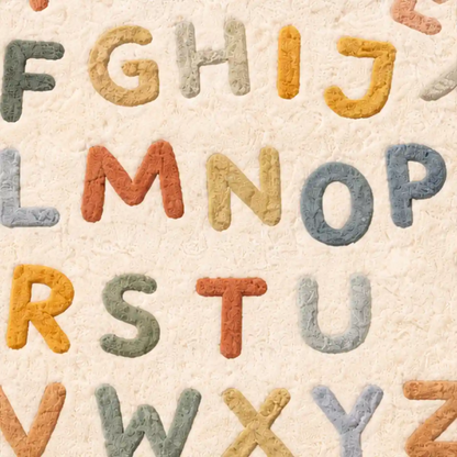 Colorful alphabet letters on a textured beige background