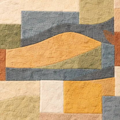 Textured quilt with geometric pattern in earthy tones