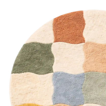 Round rug with multicolored square patterns on a white background