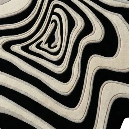 Modern organic freeform wool area rug featuring black, ivory, and grey contour lines